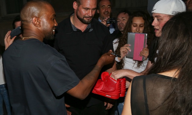 Kanye West Signing Sneakers.jpg
