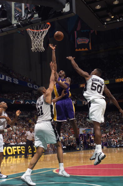 Kobe Bryant shoots over Tim Duncan and David Robinson