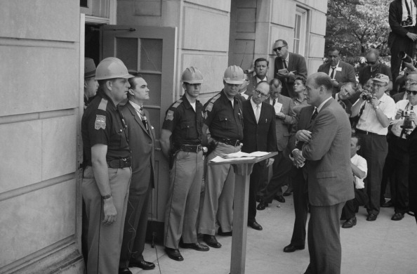 George Wallace (1919-1998) Governor of Alabama for four terms between 1963 and 1987. Wallace attempting to block integration at the University of Alabama, standing defiantly at a door while being confronted by US Deputy Attorney General Nicholas Katzenbac