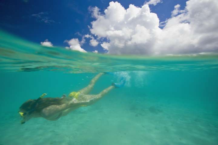 Teenage girl (15-17) snorkeling, surface view