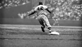 Dodger Jackie Robinson rounds first during a game against the Giants.